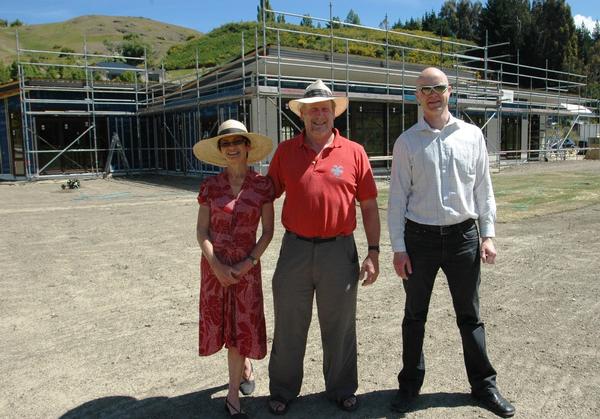 Cristina and Graham Robinson outside their new home with Mick Moffatt from Rilean Construction.